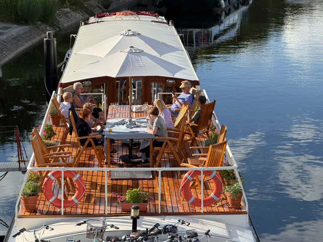 Passengers play cards on deck