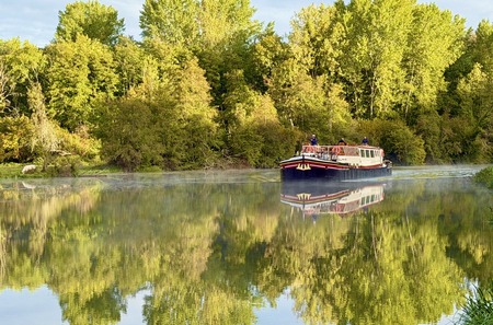 Luciole cruising through autumn reflections on the River Yonne