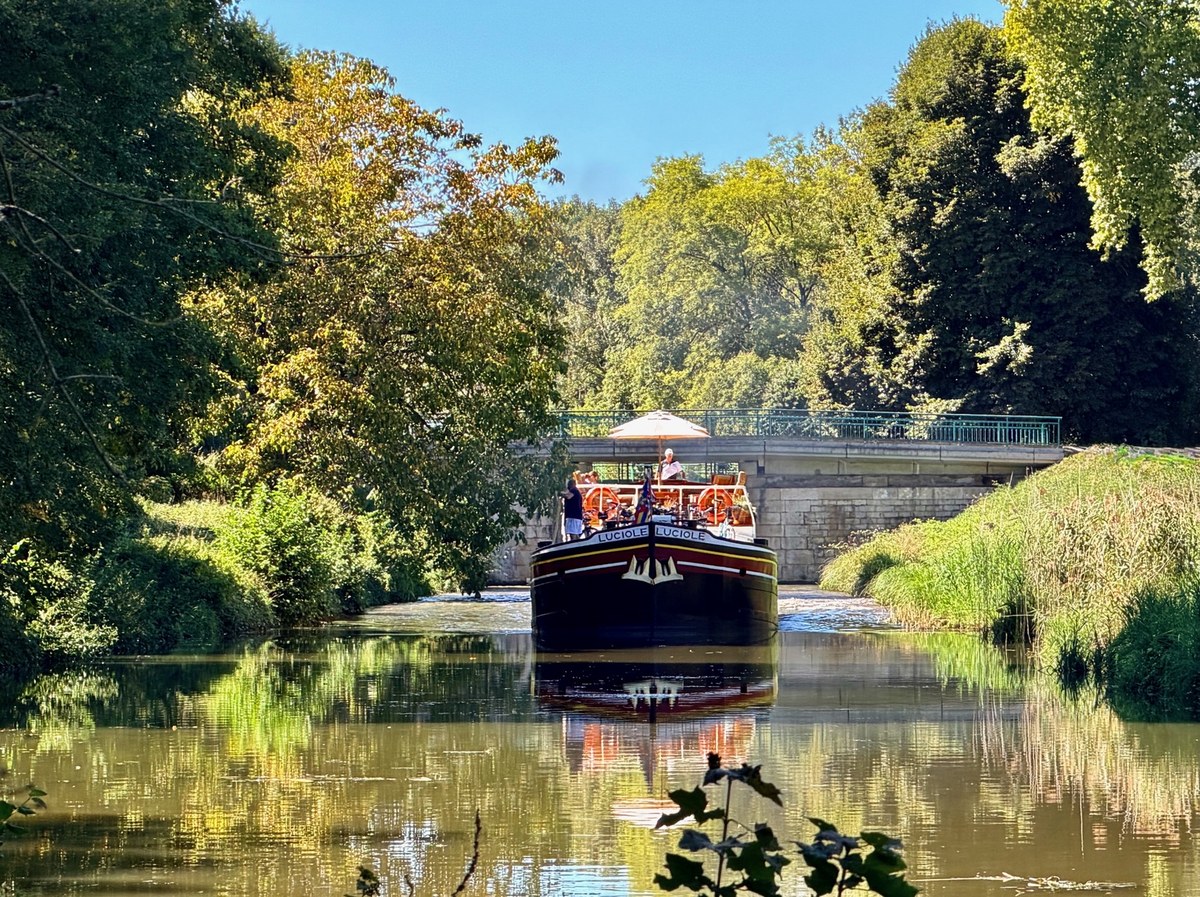 Passengers enjoying an autumn cruise aboard Hotel Barge Luciole