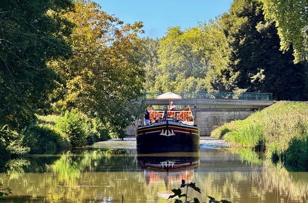 Passengers enjoying an autumn cruise aboard Hotel Barge Luciole