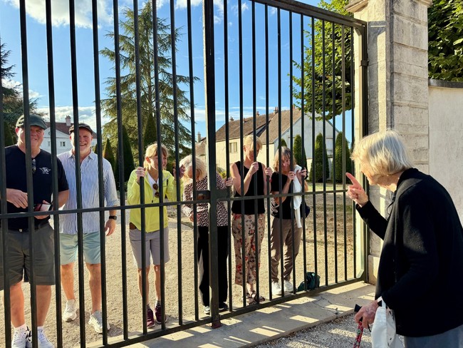 Family sharing a joke at the gates in Chablis