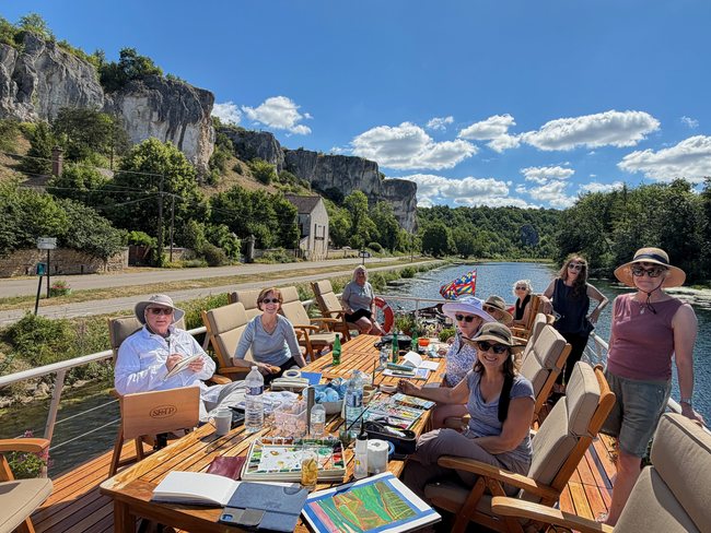Art Cruise guests painting beneath Burgundy's limestone cliffs